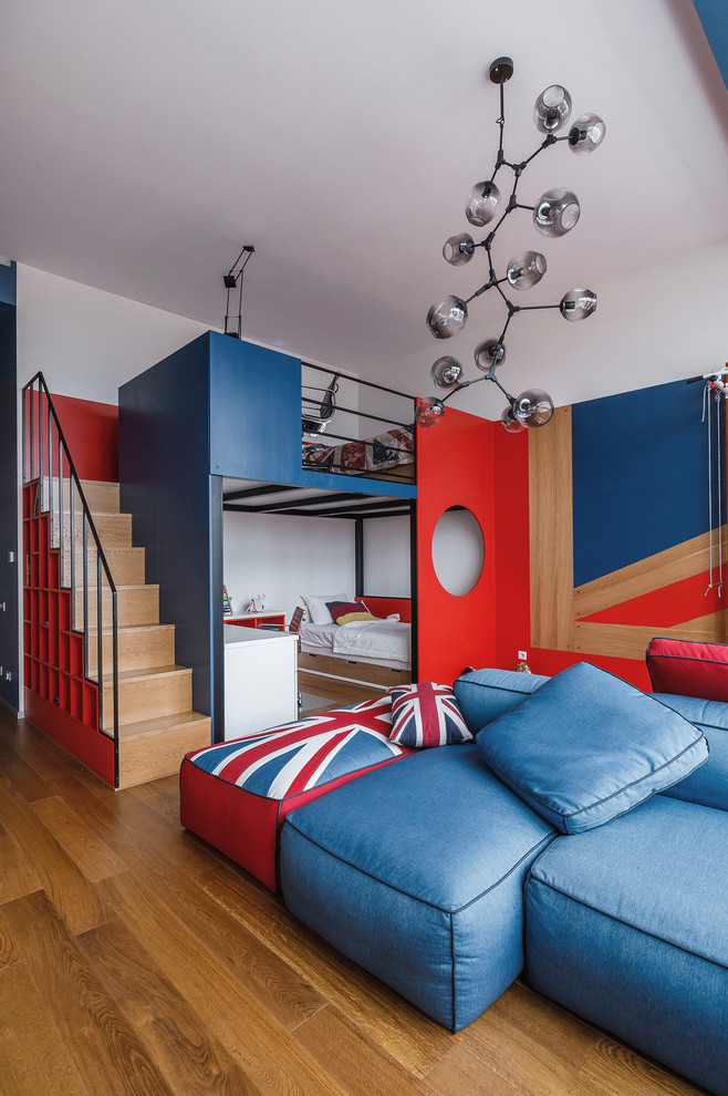 Trendy gender-neutral medium tone wood floor and brown floor kids' bedroom photo in Other with white walls