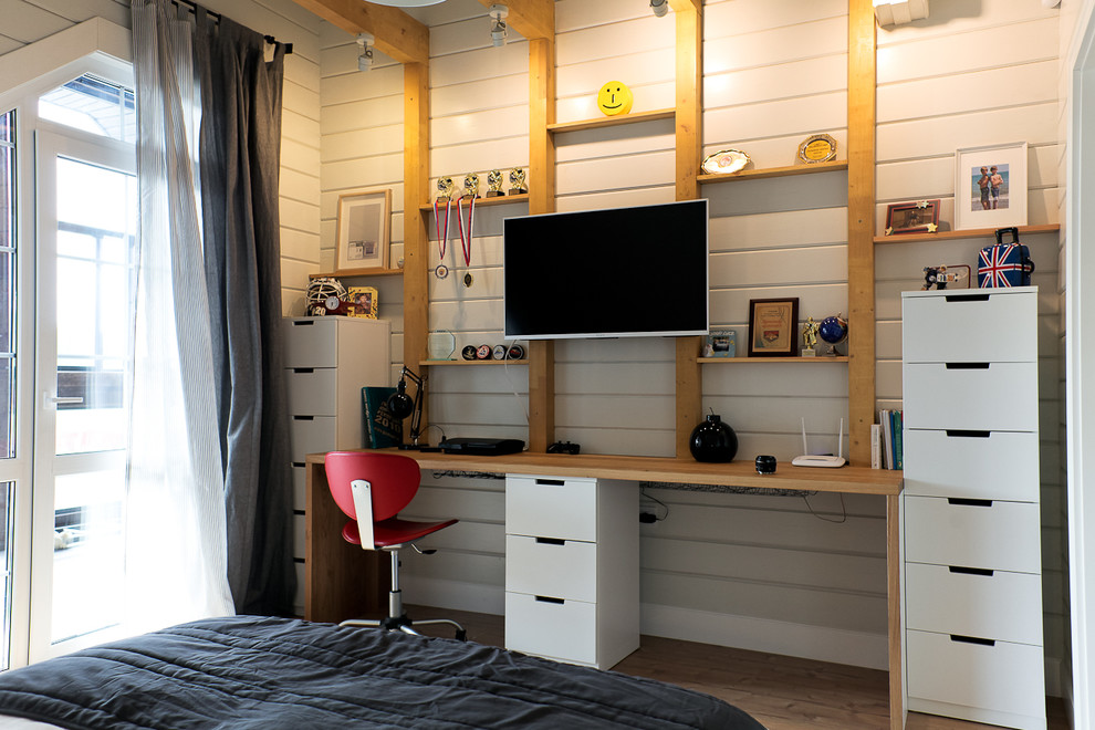 Imagen de dormitorio infantil nórdico con escritorio, paredes grises y suelo de madera clara