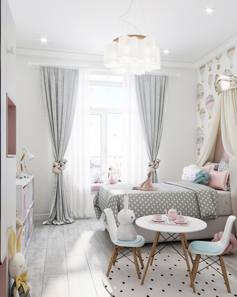 Medium sized contemporary children’s room for girls in Other with white walls, laminate floors and grey floors.