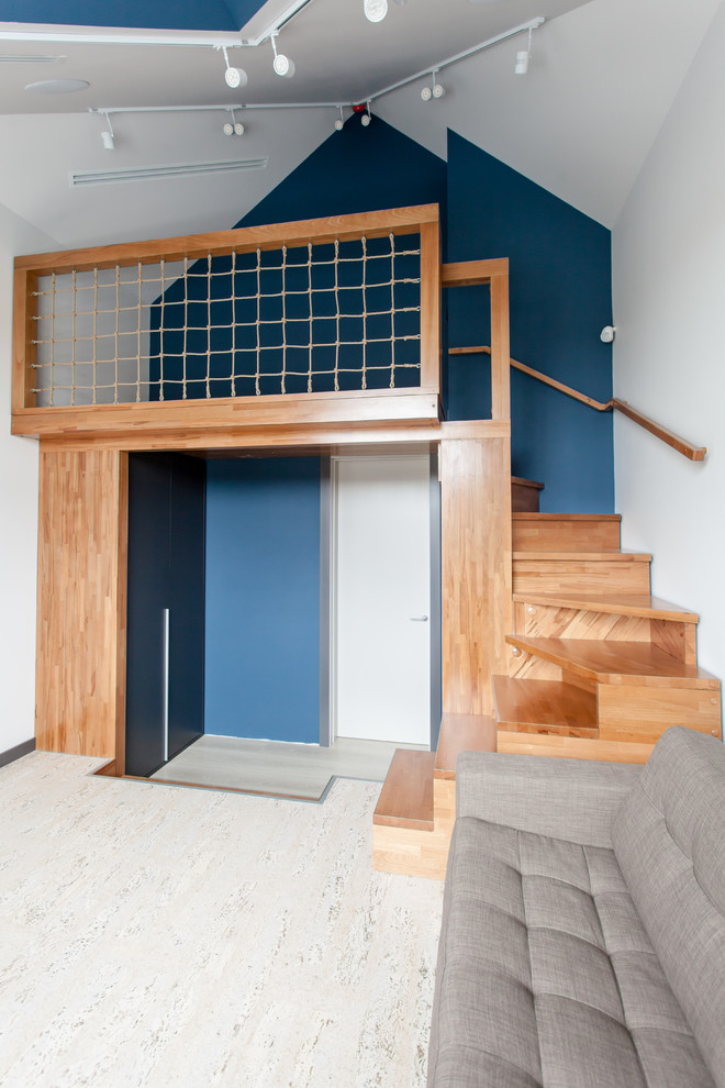 Modelo de dormitorio infantil contemporáneo de tamaño medio con paredes azules, suelo de corcho y suelo beige