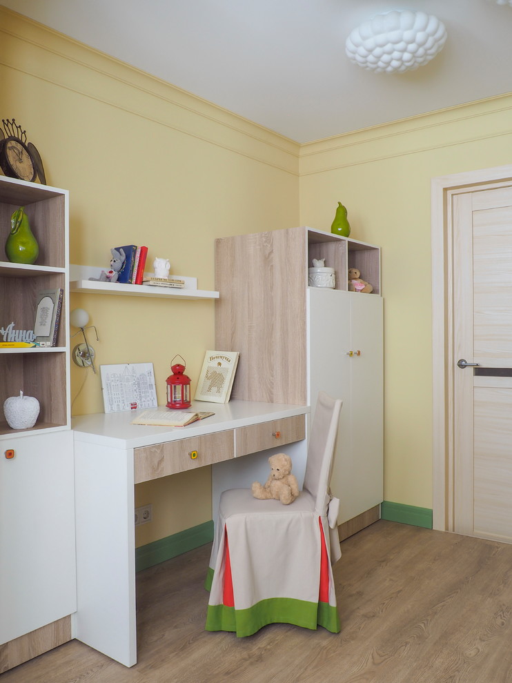 Foto på ett mellanstort funkis flickrum kombinerat med skrivbord och för 4-10-åringar, med gula väggar, laminatgolv och beiget golv