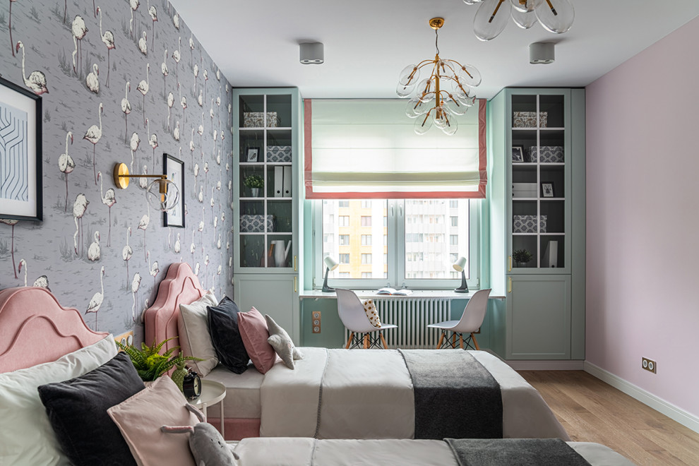 Photo of a contemporary kids' bedroom for girls in Moscow with light hardwood flooring, brown floors and wallpapered walls.
