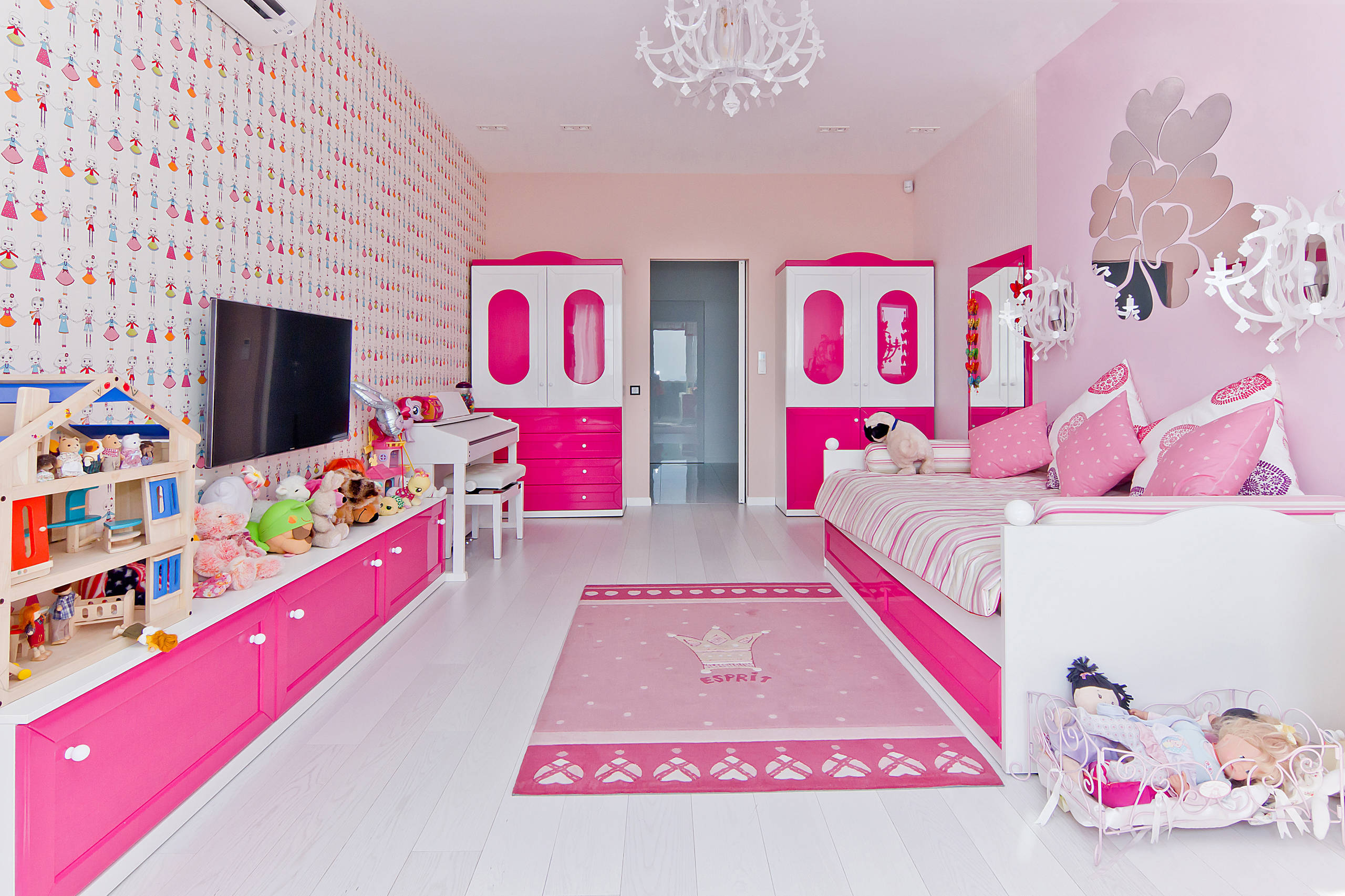 Happy family in pink pajamas in play childrens room. little • wall