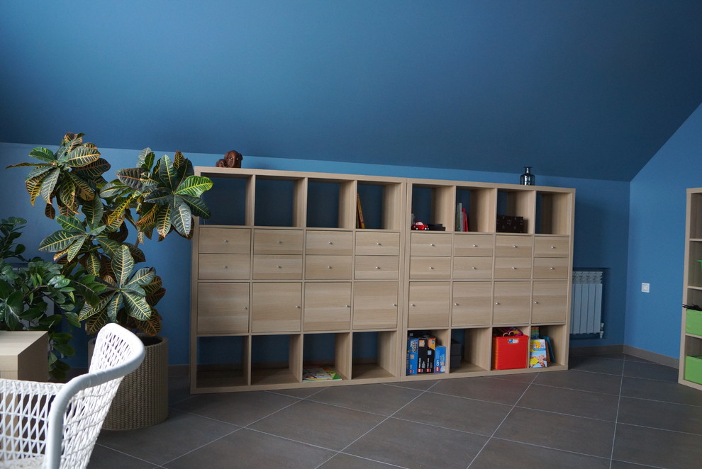 Example of a large urban boy porcelain tile and gray floor kids' room design in Other with blue walls