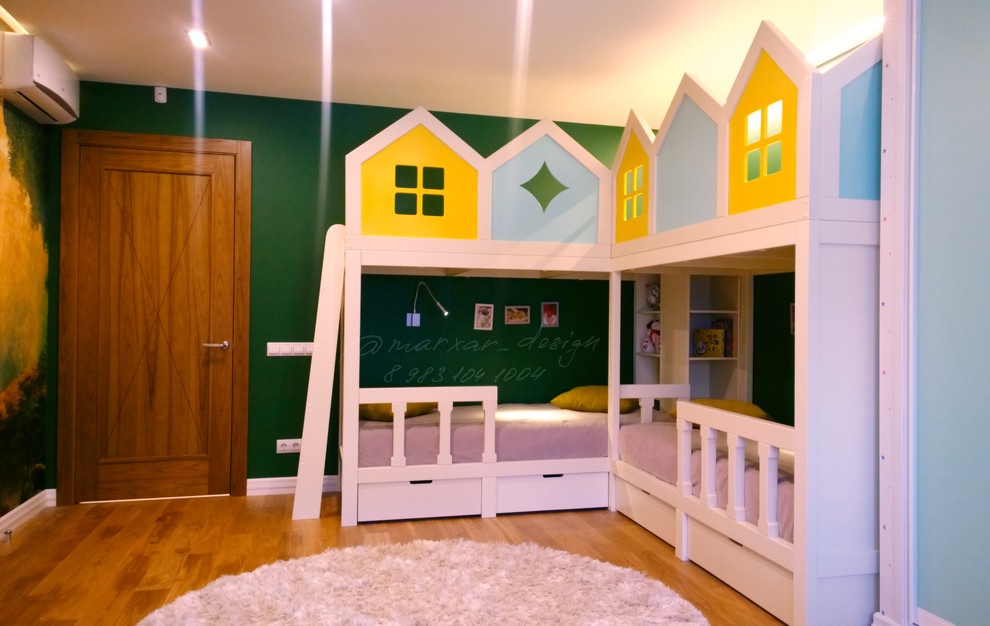 На фото: большая нейтральная детская с игровой в современном стиле с зелеными стенами, паркетным полом среднего тона и коричневым полом для ребенка от 4 до 10 лет