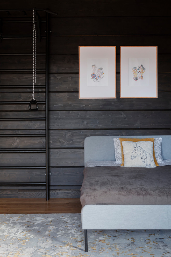 Cette image montre une chambre de garçon de 4 à 10 ans rustique en bois avec un mur noir et poutres apparentes.