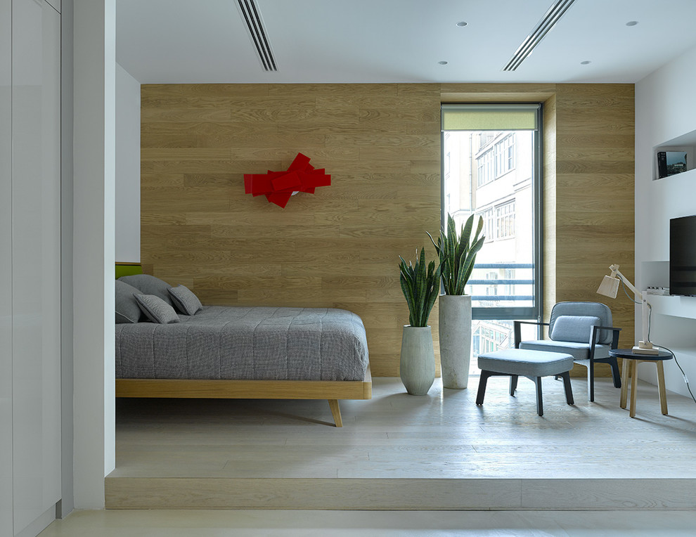 This is an example of a medium sized contemporary gender neutral teen’s room in Moscow with light hardwood flooring, brown walls, beige floors and feature lighting.