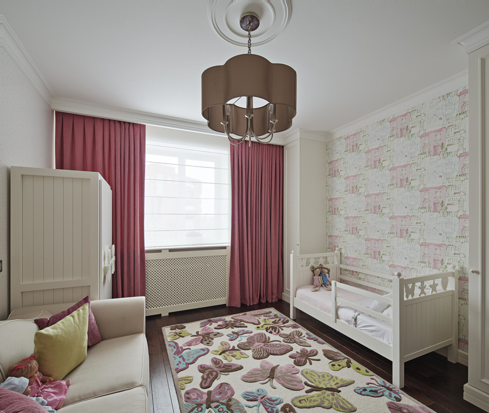 Design ideas for a contemporary toddler’s room for girls in Moscow with white walls, dark hardwood flooring and brown floors.