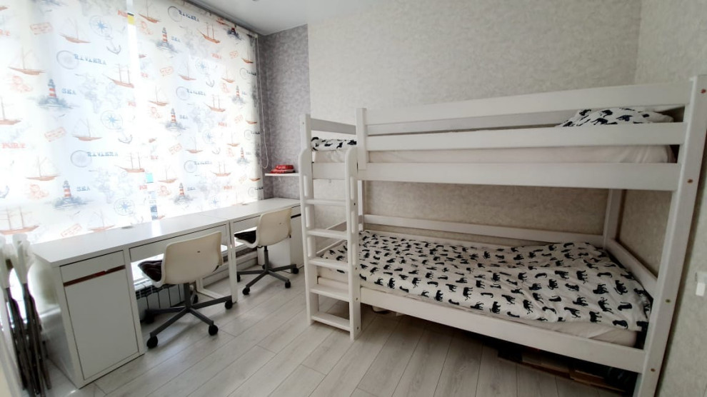 This is an example of a small contemporary teen’s room for boys in Other with grey walls, laminate floors, grey floors and wallpapered walls.