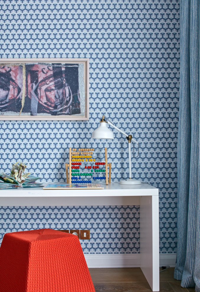 Cette image montre une chambre neutre de 4 à 10 ans design avec un bureau, un mur bleu et un sol en bois brun.