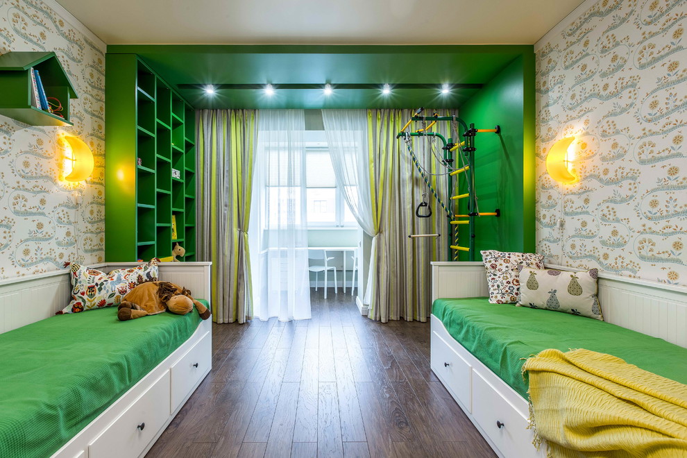 Traditional gender neutral children’s room in Other with green walls and dark hardwood flooring.