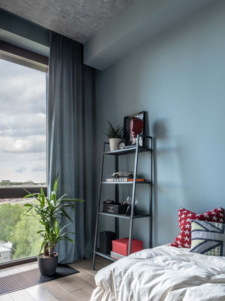 Idéer för ett mellanstort skandinaviskt barnrum kombinerat med sovrum, med blå väggar
