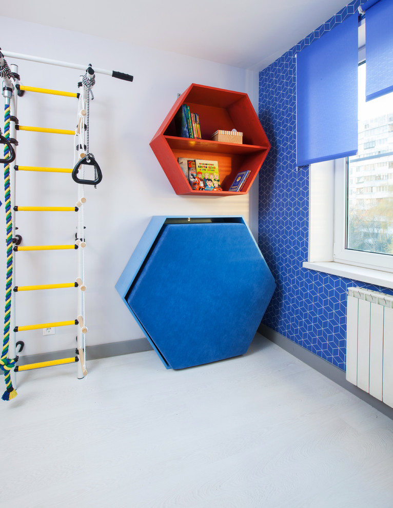 Réalisation d'une petite chambre d'enfant de 4 à 10 ans design avec un mur bleu et parquet clair.