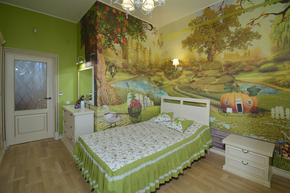 This is an example of a medium sized traditional children’s room for girls in Other with green walls, light hardwood flooring and beige floors.