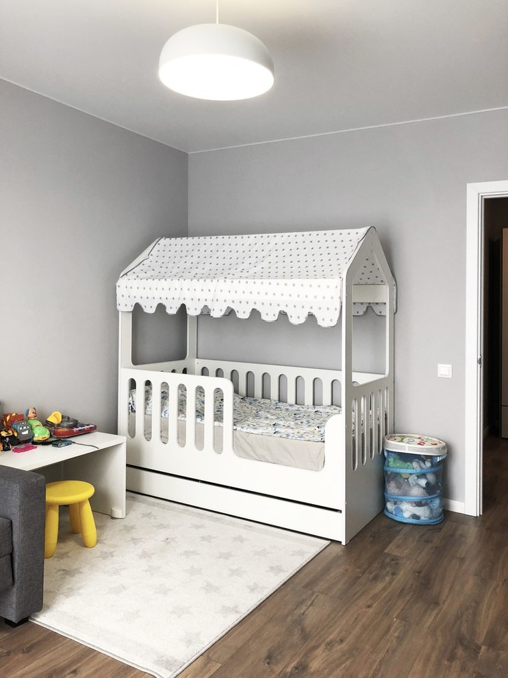 Idee per una cameretta per bambini da 4 a 10 anni scandinava di medie dimensioni con pareti blu, pavimento in laminato e pavimento marrone