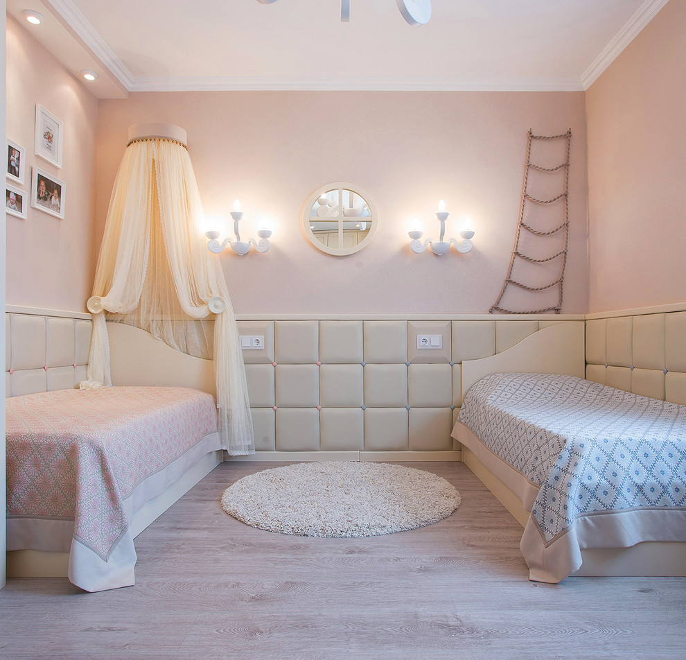 Medium sized classic gender neutral children’s room in Moscow with beige walls and light hardwood flooring.