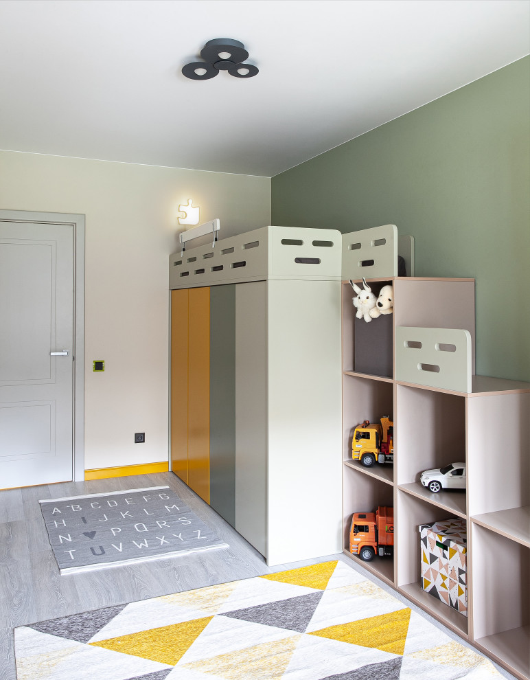 This is an example of a scandinavian gender neutral kids' bedroom in Saint Petersburg with green walls and grey floors.
