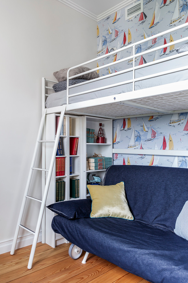 Example of a small trendy boy medium tone wood floor and beige floor kids' room design in Moscow with white walls