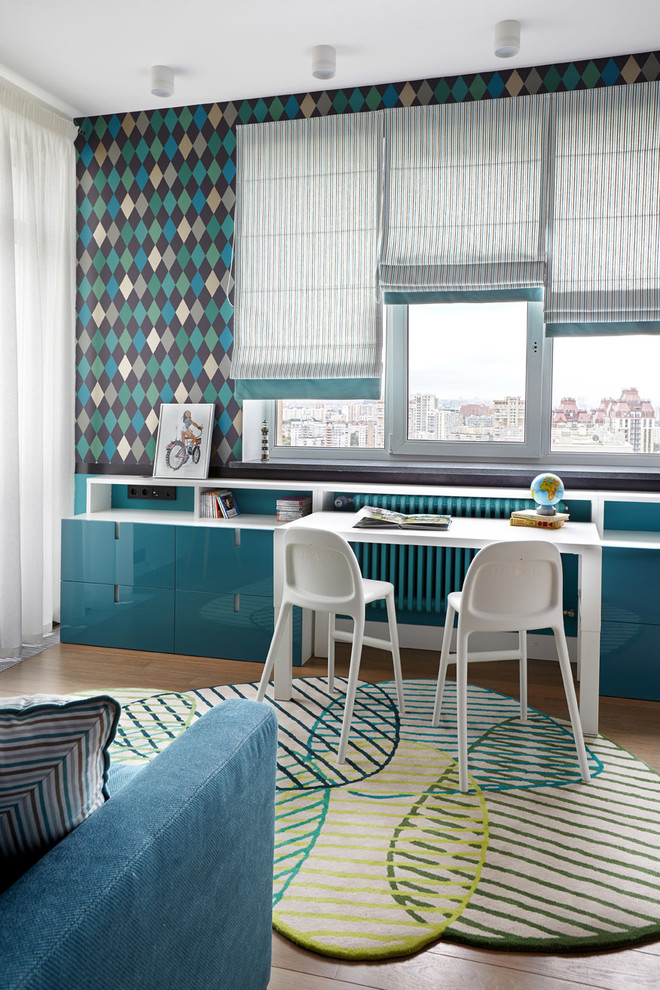 This is an example of a medium sized contemporary kids' bedroom for boys in Moscow with multi-coloured walls and medium hardwood flooring.