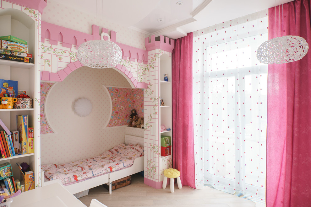 Classic children’s room for girls in Saint Petersburg with white walls, light hardwood flooring and beige floors.