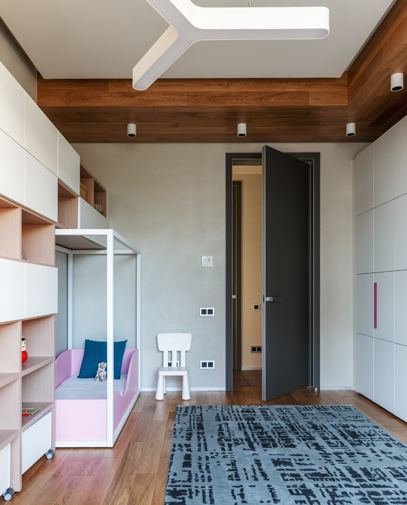 Kids' room - large contemporary girl medium tone wood floor and brown floor kids' room idea in Moscow with white walls