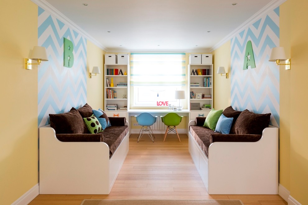Inspiration for a contemporary gender neutral children’s room in Moscow with yellow walls and light hardwood flooring.