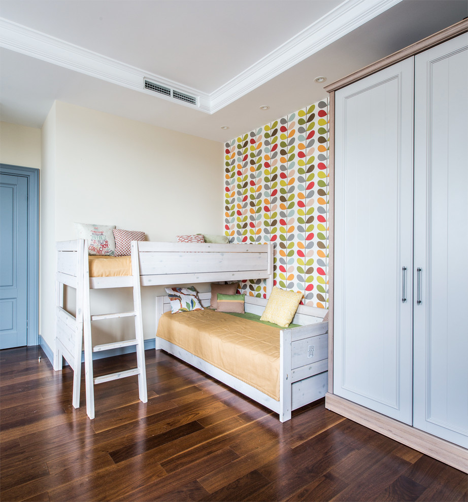 This is an example of a medium sized classic gender neutral children’s room in Moscow with multi-coloured walls, dark hardwood flooring and brown floors.