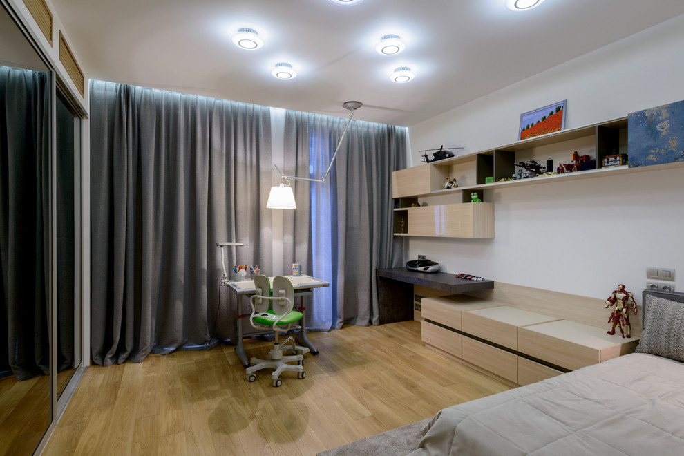 This is an example of a contemporary kids' bedroom in Novosibirsk with medium hardwood flooring.