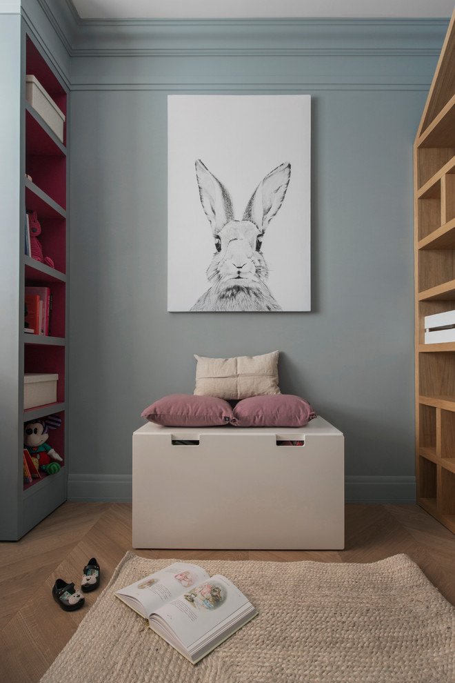 Photo of a contemporary kids' bedroom for girls in Moscow with grey walls and medium hardwood flooring.