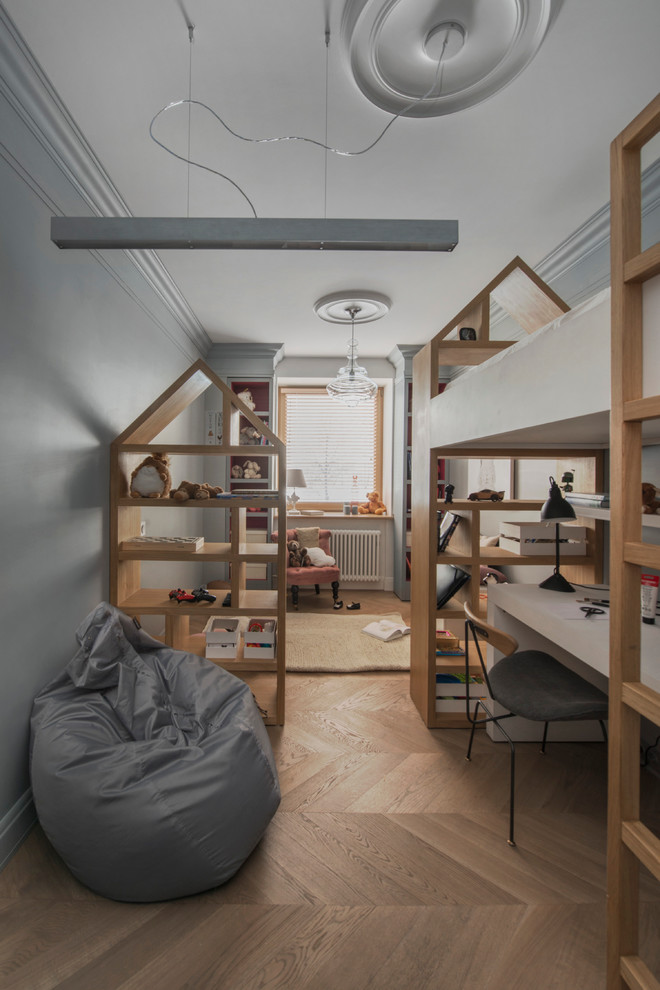 Example of a danish girl medium tone wood floor and beige floor kids' room design in Moscow with gray walls