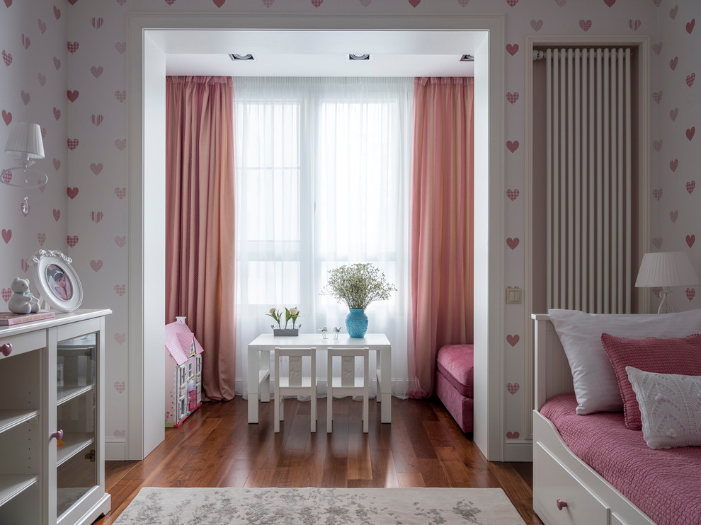 Example of a transitional girl medium tone wood floor and brown floor kids' room design in Moscow with white walls