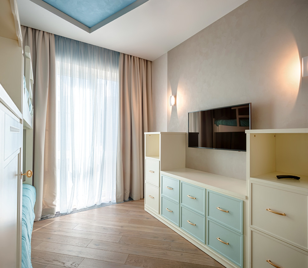 Large contemporary children’s room for girls in Moscow with beige walls, light hardwood flooring and beige floors.