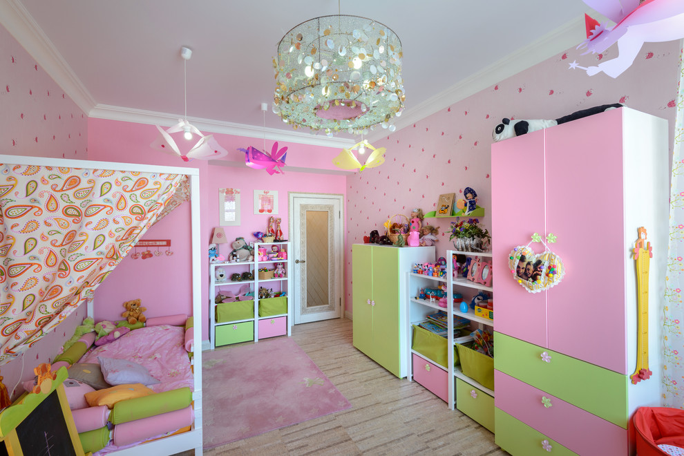 This is an example of a large contemporary playroom for girls in Novosibirsk with pink walls and cork flooring.