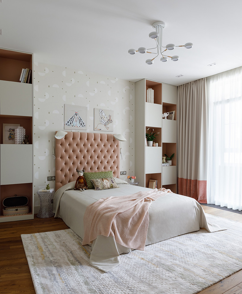 Design ideas for a contemporary children’s room for girls in Moscow with beige walls, medium hardwood flooring and brown floors.