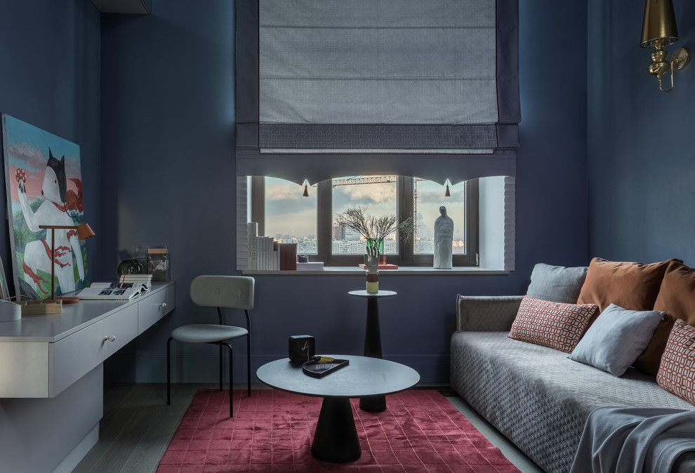 Idée de décoration pour une chambre neutre design avec un bureau, un mur bleu, parquet foncé et un sol noir.