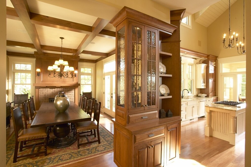 Kitchen/dining room combo - mid-sized traditional medium tone wood floor kitchen/dining room combo idea in Cedar Rapids with beige walls, a ribbon fireplace and a tile fireplace