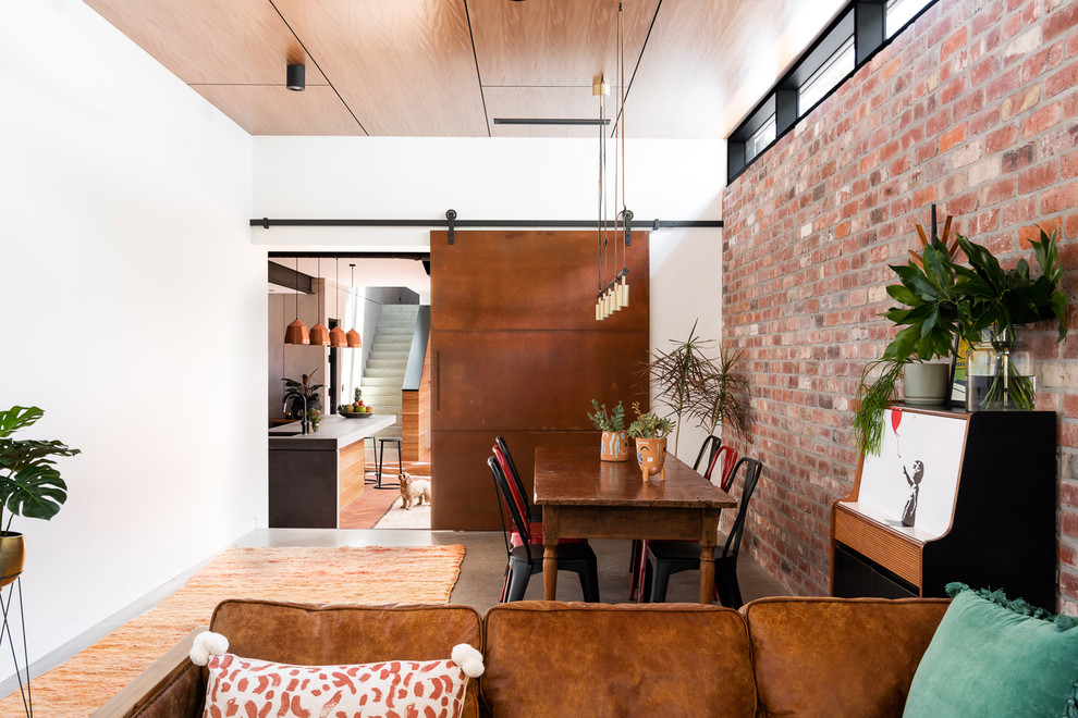 Kitchen/dining room combo - mid-sized industrial concrete floor and gray floor kitchen/dining room combo idea in Perth with white walls and no fireplace