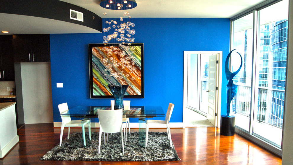 Small modern kitchen/dining room in Atlanta with blue walls and medium hardwood flooring.