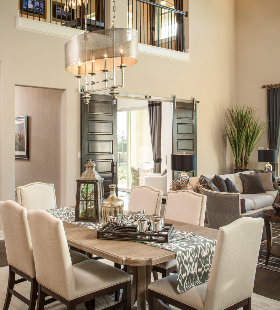 Design ideas for a classic open plan dining room in Austin with beige walls, dark hardwood flooring and feature lighting.