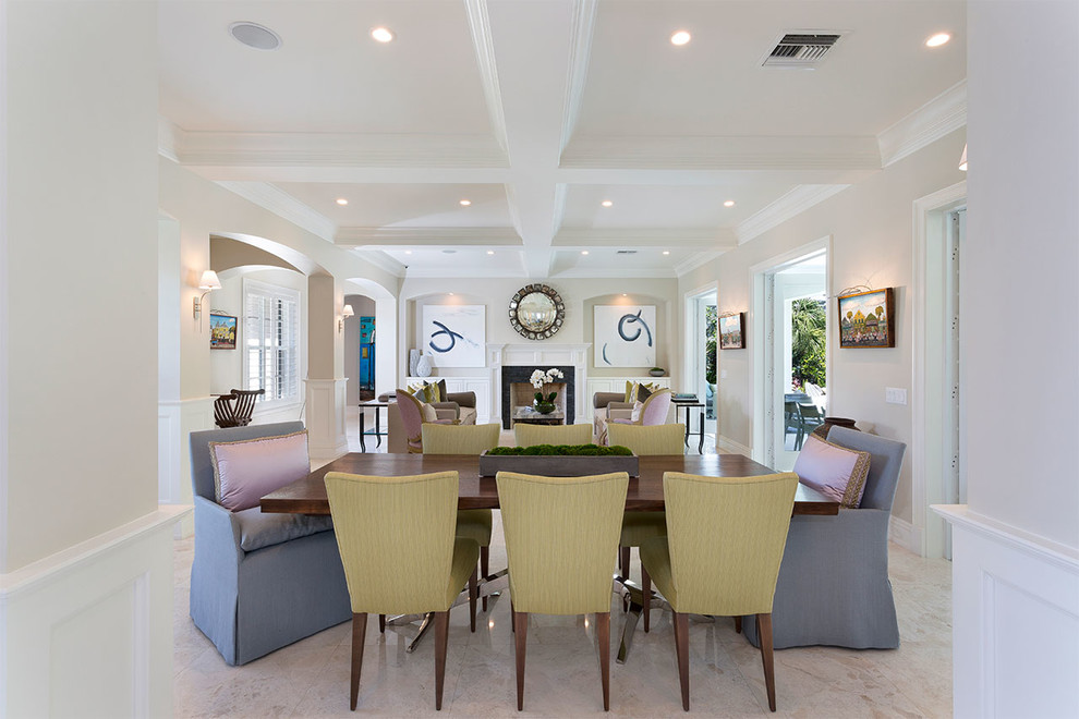Inspiration for a coastal dining room in Miami with white walls and white floors.