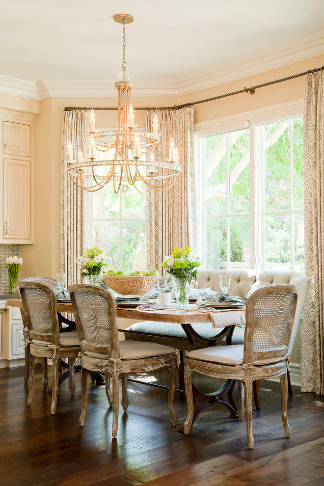 Example of a classic dining room design in Los Angeles with yellow walls