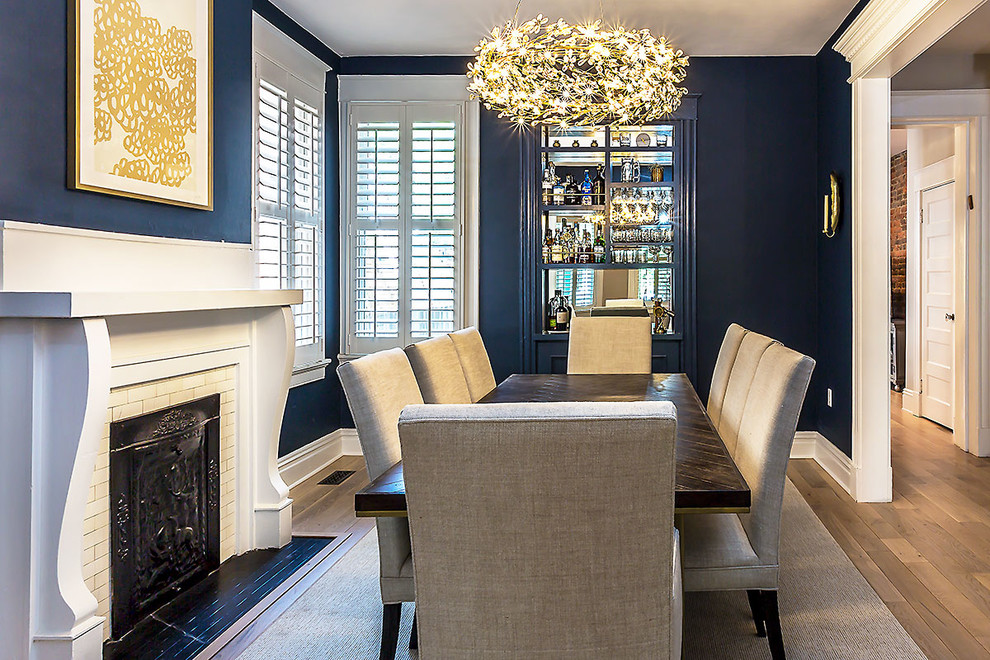 Enclosed dining room - mid-sized traditional light wood floor enclosed dining room idea in Richmond with blue walls, a standard fireplace and a tile fireplace