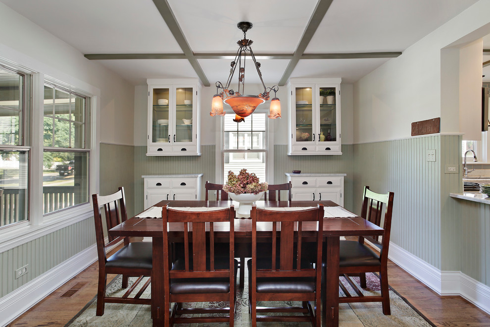 Photo of a medium sized traditional kitchen/dining room in Chicago with medium hardwood flooring, no fireplace, beige walls and brown floors.