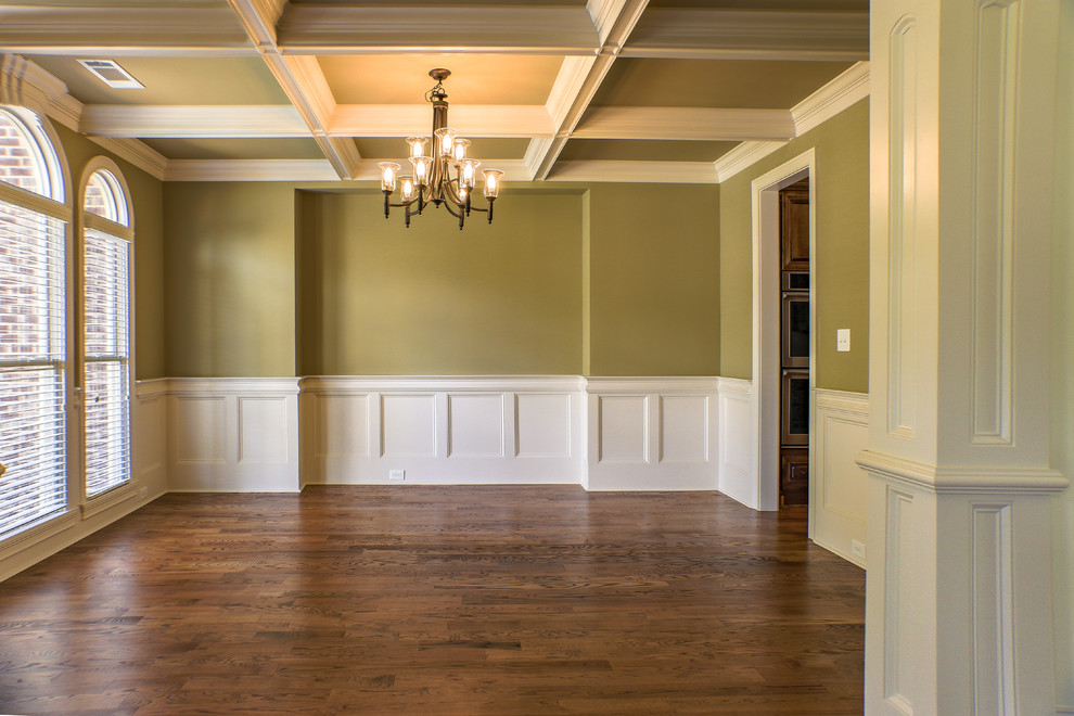 Photo of a large traditional enclosed dining room in Atlanta with green walls and dark hardwood flooring.