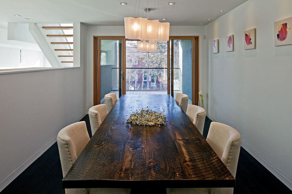 This is an example of a contemporary dining room in Toronto with white walls.