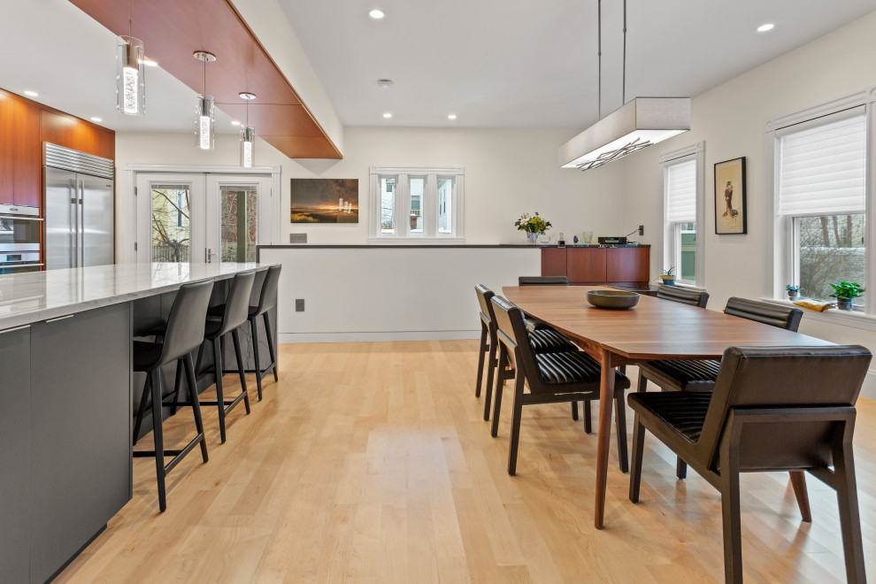 Inspiration for a mid-sized modern light wood floor and beige floor kitchen/dining room combo remodel in Boston with white walls and no fireplace