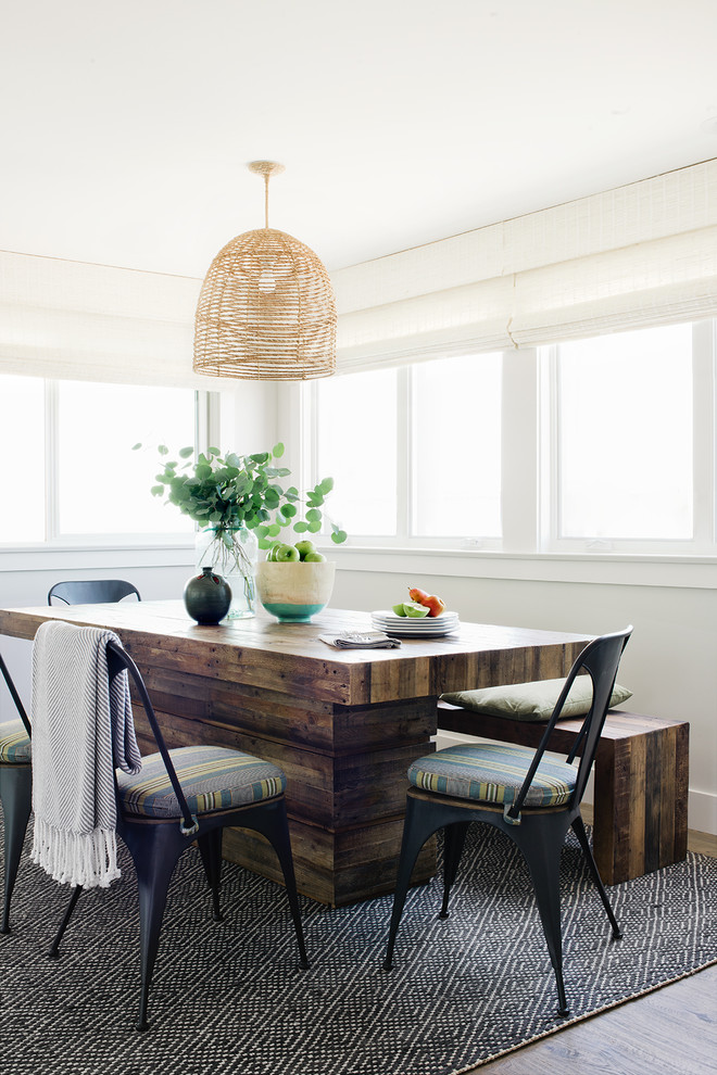 Design ideas for a coastal dining room in Los Angeles with white walls, medium hardwood flooring and brown floors.