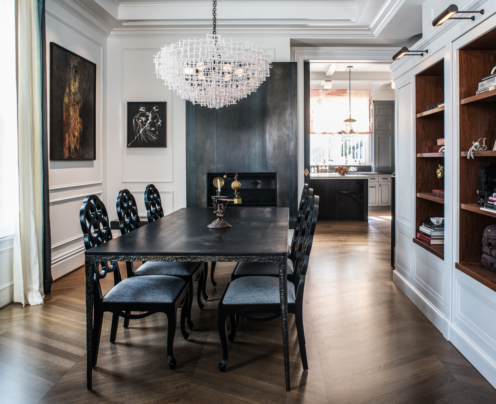 Design ideas for a traditional dining room in San Francisco with white walls, medium hardwood flooring, a standard fireplace, a metal fireplace surround and brown floors.