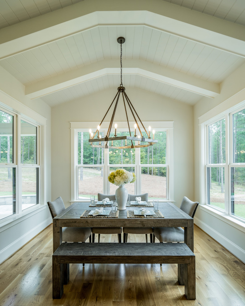 Design ideas for a country dining room in Raleigh with grey walls, medium hardwood flooring and brown floors.