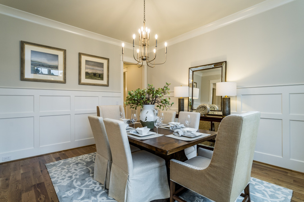 Large country dining room in Raleigh with grey walls, medium hardwood flooring and brown floors.